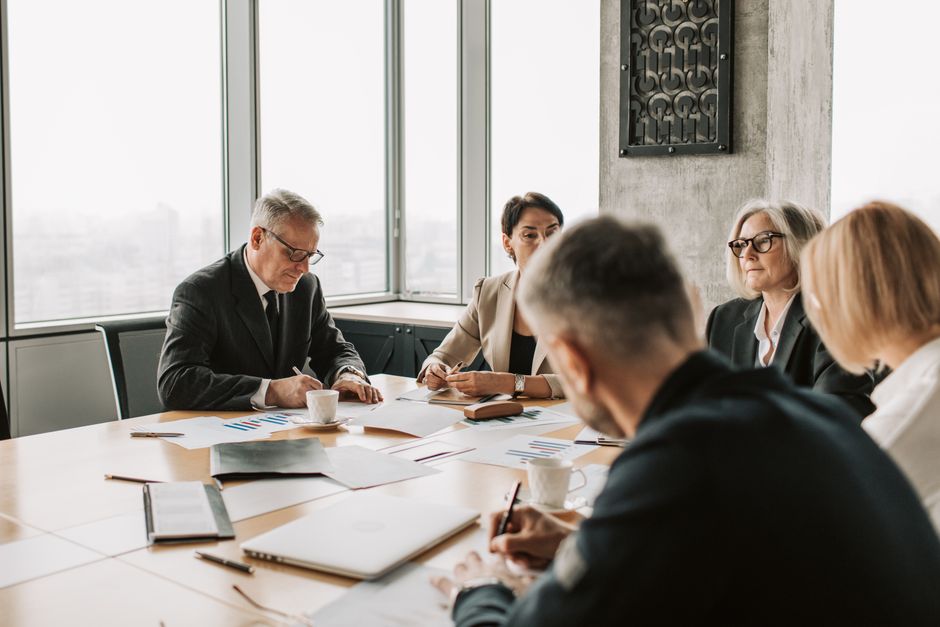 Business professionals engaged in a collaborative meeting around a conference table.